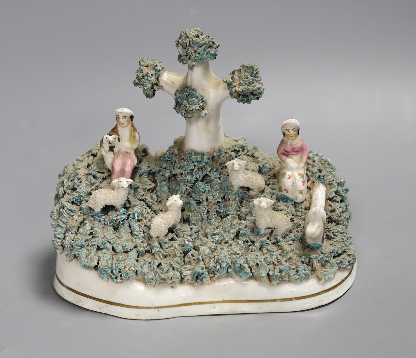 A Staffordshire porcelain lambing group, c.1830-50, 13.5cm tall